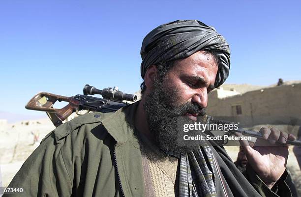 Taliban sniper Mohamed Said Kouchai surrenders of at the village Maidan Shar, 30 miles south of Kabul, after a week-long, violent stand-off with...