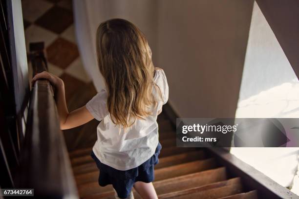 girl walking down stairs - northern european descent stockfoto's en -beelden