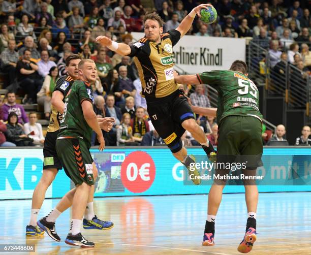 Erik Schmidt, Paul Drux, Kai Haefner of TSV Hannover Burgdorf and Drasko Nenadic of Fuechse Berlin during the game between Fuechse Berlin and TSV...