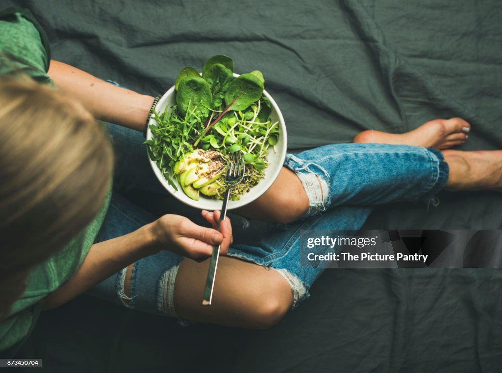 Vegan breakfast meal with spinach, arugula, avocado, seeds and sprouts