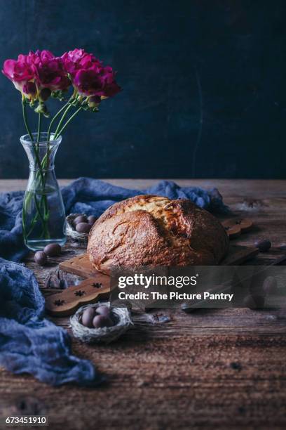 freshly baked sweet easter bread on a wooden board - sweet bread fotografías e imágenes de stock