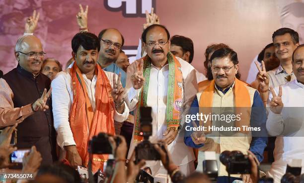 Delhi BJP President Manoj Tiwari along with Venkaiah Naidu showing sign of victory during a press conference at Delhi BJP Office after party's...