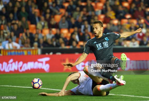 Guilherme Siqueira of Valencia CF and Sergio Canales of Real Sociedad during their La Liga match between Valencia CF and Real Sociedad, at the...