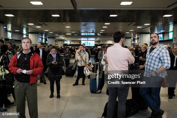 Passengers wait to board a train at Pennsylvania Station on April 26, 2017 in New York City. Following two recent derailments at the crowded...