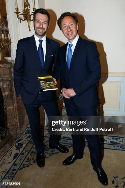 Christos Markogiannakis and Stephane Bern attend the presentation of the Book "Scenes De Crime au Louvre", written by Christos Markogiannakis at...