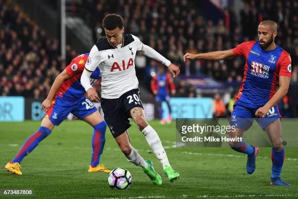 Dele Alli of Tottenham Hotspur takes the ball past Andros Townsend of Crystal Palace during the Premier League match between Crystal Palace and...