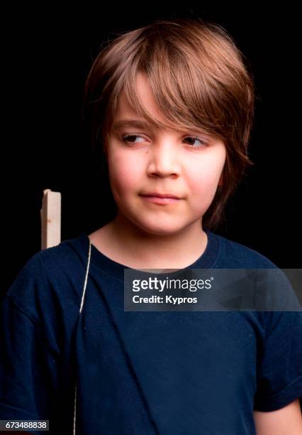 studio shot little boy age 8 years wearing blue t-shirt - 8 9 years stock pictures, royalty-free photos & images