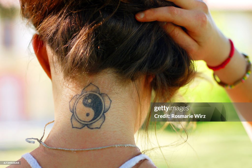 Tattoo on young woman's nape
