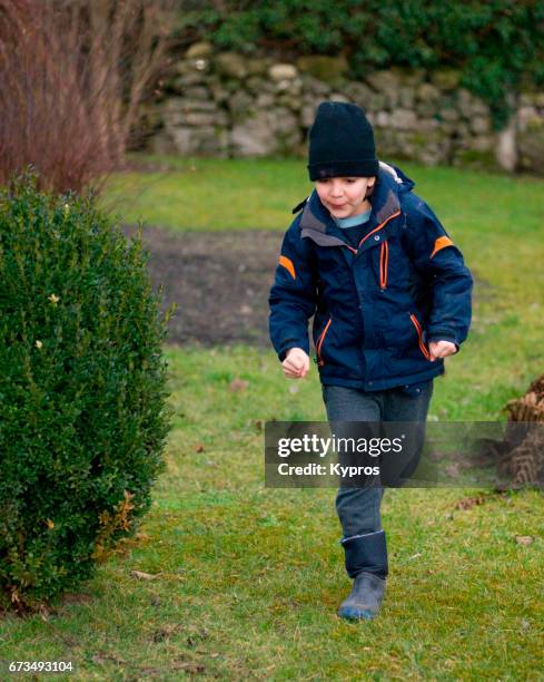 little boy age 8 years running in garden - 8 9 years foto e immagini stock