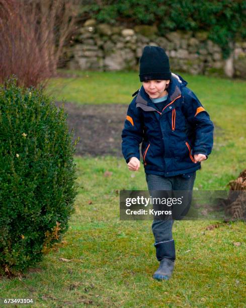 little boy age 8 years running in garden - 8 9 years stock pictures, royalty-free photos & images