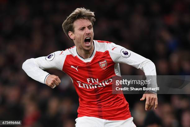 Nacho Monreal of Arsenal celebrates after his shot was deflceted onto Robert Huth of Leicester City leading to Arsenal's first goal during the...