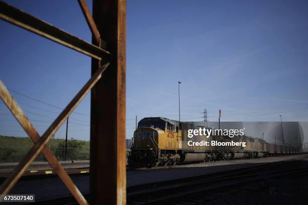 Union Pacific Corp. Freight locomotives sit parked with a Herzog Railroad Services Inc. Ballast train along the Mississippi River in St. Louis,...