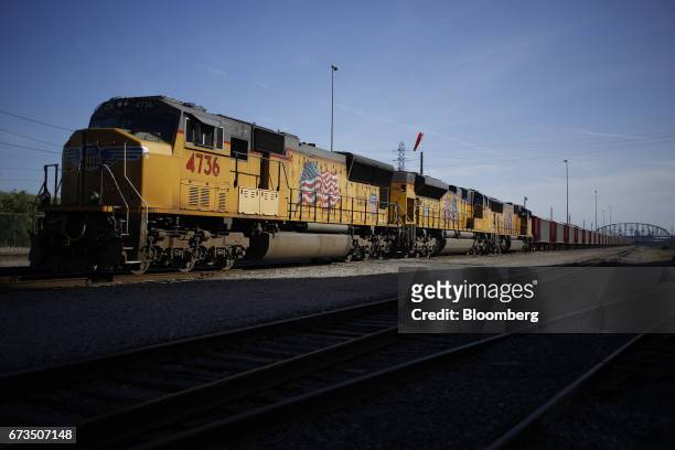 Union Pacific Corp. Freight locomotives sit parked with a Herzog Railroad Services Inc. Ballast train along the Mississippi River in St. Louis,...