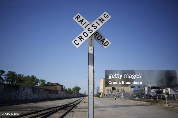 Railroad crossing crossbuck sign stands along Union Pacific Corp. Train tracks in St. Louis, Missouri, U.S., on Tuesday, April. 25, 2017. Union...