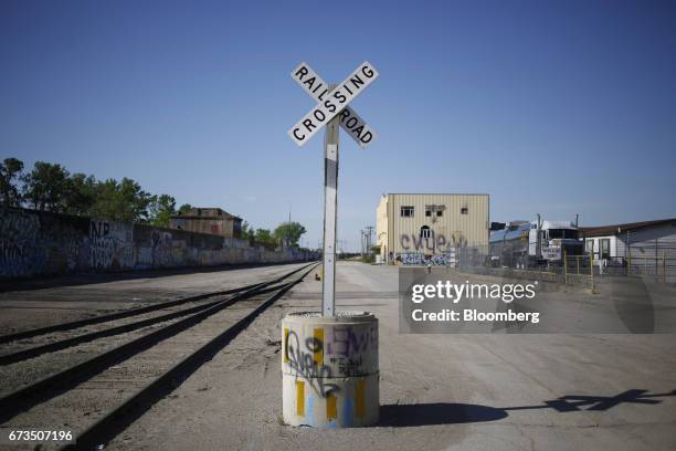 Railroad crossing crossbuck sign stands along Union Pacific Corp. Train tracks in St. Louis, Missouri, U.S., on Tuesday, April. 25, 2017. Union...