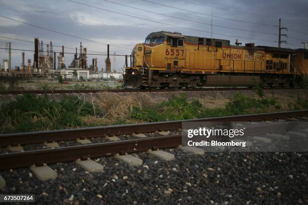Union Pacific Corp. Freight train passes by an oil refinery in Roxana, Illinois, U.S., on Tuesday, April. 25, 2017. Union Pacific Corp. Is scheduled...