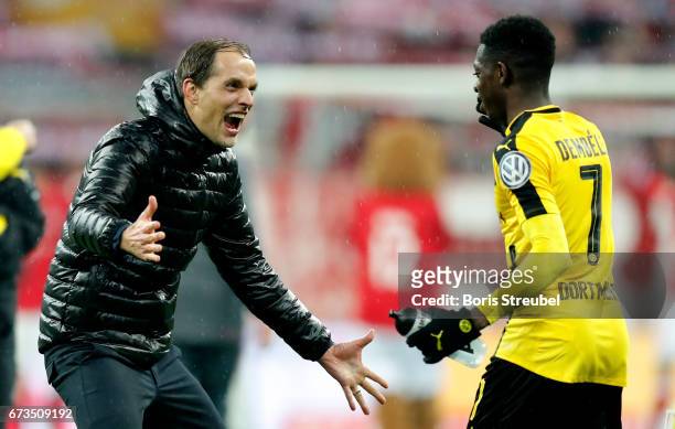 Thomas Tuchel, head coach of Dortmund celebrate victory with Ousmane Dembele after the DFB Cup semi final match between FC Bayern Muenchen and...