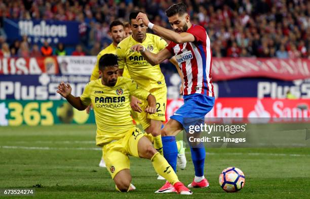 Yanick Carrasco of Atletico Madrid and Jaume Costa of Villarreal and Bruno Soriano of Villarreal battle for the ball during the La Liga match between...