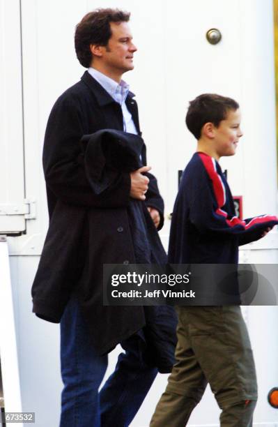 Actor Colin Firth leaves his trailer with his son Will on the set of his upcoming film "New Cardiff" November 26, 2001 in Vancouver, British Columbia.