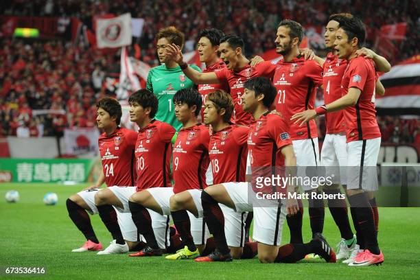 Players of Urawa Red Diamonds pose for a team photo on the field prior to the AFC Champions League Group F match between Urawa Red Diamonds and...