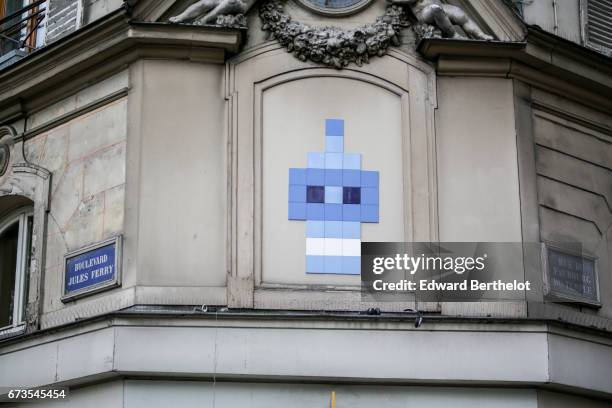 Street art graffiti showing a blue character made of tiles is seen between Boulevard Jules Ferry and Rue du Faubourg du Temple, on April 16, 2017 in...