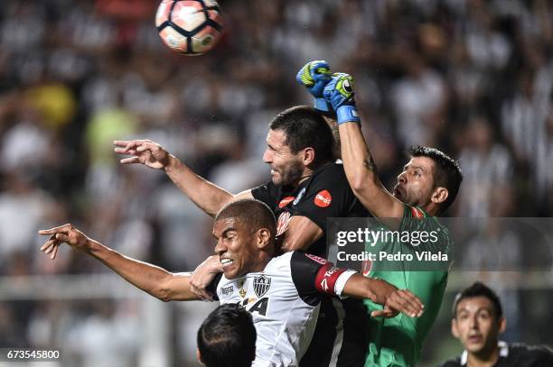 Leonardo Silva of Atletico MG and Alcaraz and Munoz of Libertad battle for the ball during a match between Atletico MG and Libertad as part of Copa...