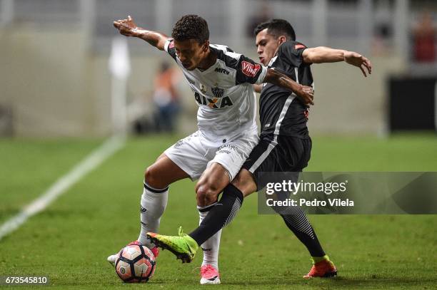 Marcos Rocha of Atletico MG and Medina of Libertad battle for the ball during a match between Atletico MG and Libertad as part of Copa Bridgestone...