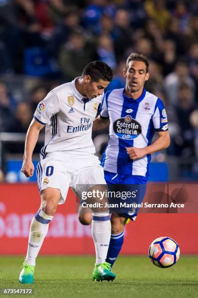 James Rodriguez of Real Madrid duels for the ball with Fernando Navarro of RC Deportivo La Coruna during the La Liga match between RC Deportivo La...