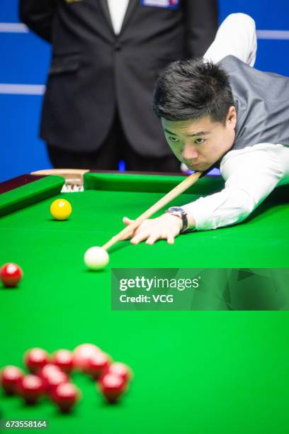 Ding Junhui of China plays a shot during his quarter final match against Ronnie O'Sullivan of England on day twelve of Betfred World Championship...