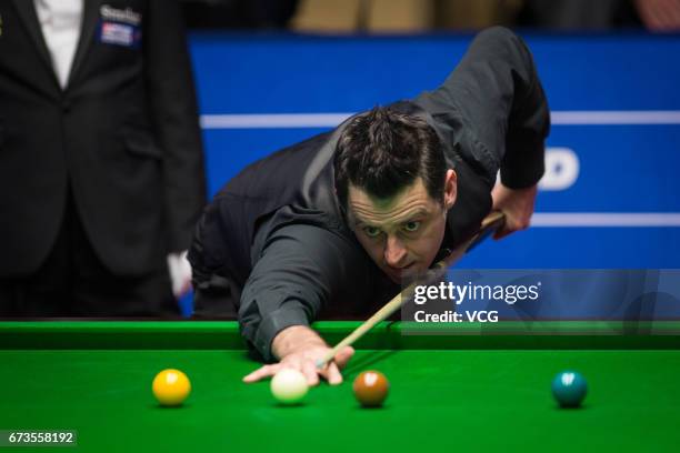 Ronnie O'Sullivan of England plays a shot during his quarter final match against Ding Junhui of China on day twelve of Betfred World Championship...