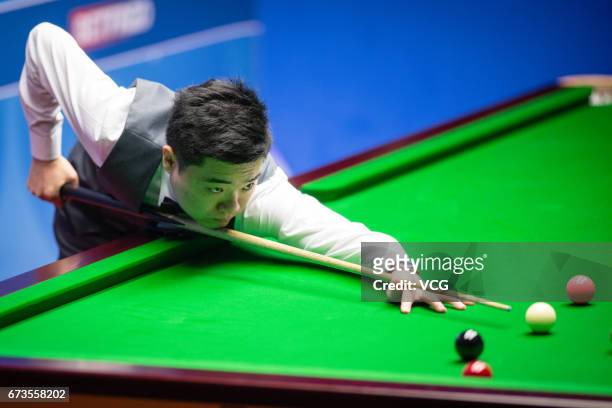 Ding Junhui of China plays a shot during his quarter final match against Ronnie O'Sullivan of England on day twelve of Betfred World Championship...