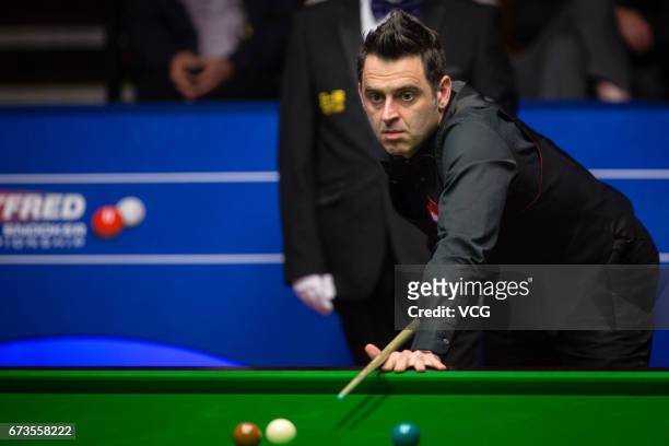 Ronnie O'Sullivan of England reacts during his quarter final match against Ding Junhui of China on day twelve of Betfred World Championship 2017 at...
