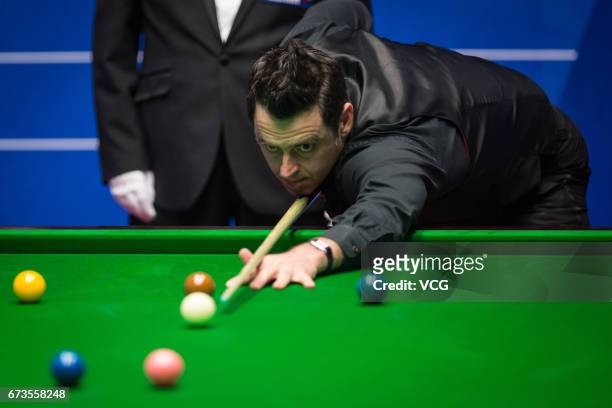 Ronnie O'Sullivan of England plays a shot during his quarter final match against Ding Junhui of China on day twelve of Betfred World Championship...