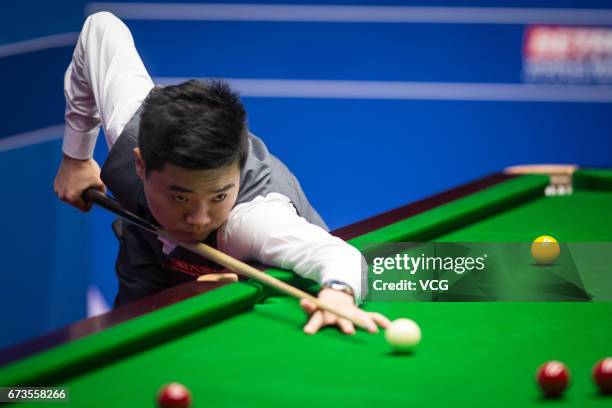 Ding Junhui of China plays a shot during his quarter final match against Ronnie O'Sullivan of England on day twelve of Betfred World Championship...