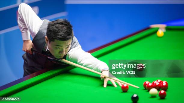 Ding Junhui of China plays a shot during his quarter final match against Ronnie O'Sullivan of England on day twelve of Betfred World Championship...