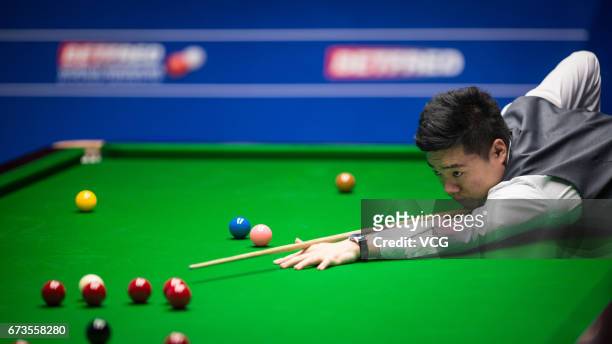 Ding Junhui of China plays a shot during his quarter final match against Ronnie O'Sullivan of England on day twelve of Betfred World Championship...