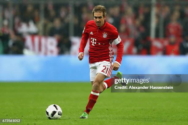 Philipp Lahm of Muenchen runs with the ball during the DFB Cup semi final match between FC Bayern Muenchen and Borussia Dortmund at Allianz Arena on...