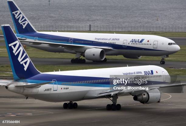 All Nippon Airways Co. Aircraft taxi at Haneda Airport in Tokyo, Japan, on Wednesday, April 26, 2017. ANA is scheduled to release Fourth-quarter...