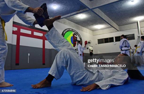 "Piranha Team" members participate in a krav maga self-defence technique class in Rio de Janeiro, Brazil, on April 18, 2017. - A group of LGBT...