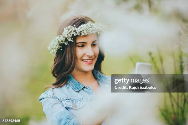 teenager girl taking selfie - flower crown stock pictures, royalty-free photos & images