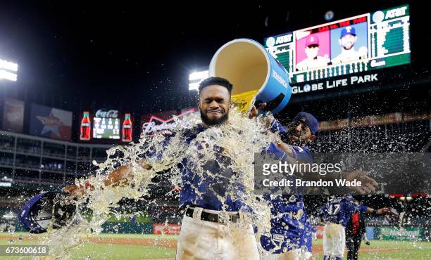 Delino DeShields of the Texas Rangers receives a sports drink bath from Rougned Odor in celebration of a 14-3 win over the Minnesota Twins at Globe...