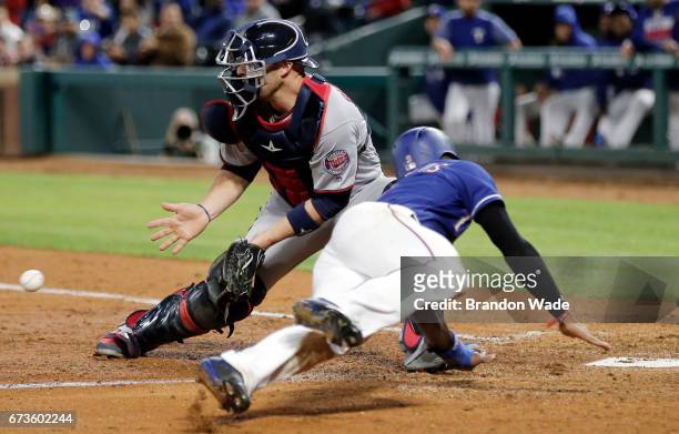 Catcher Chris Gimenez of the Minnesota Twins is late with tag on Delino DeShields of the Texas Rangers as he scores on a two-run double off the bat...