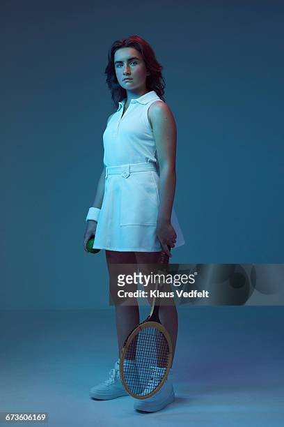 portrait of young female tennis champion - sport blue background stockfoto's en -beelden