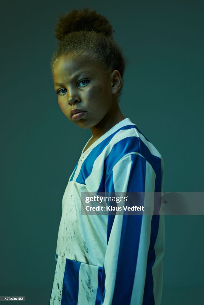 Portrait of cool young female football player