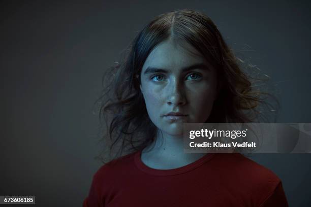 portrait of young woman dressed in red - child portrait studio stockfoto's en -beelden