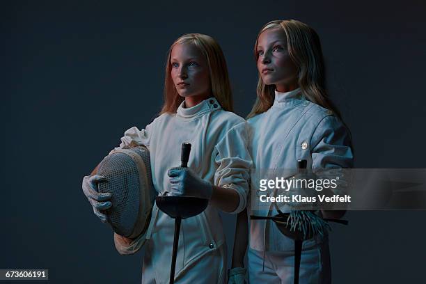 portrait of 2 young twin fencers looking out - twin stock-fotos und bilder