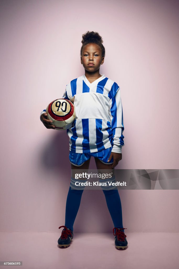 Portrait of cool young female football player