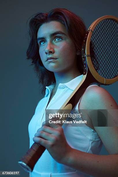 portrait of young female tennis champion - sport blue background stock-fotos und bilder