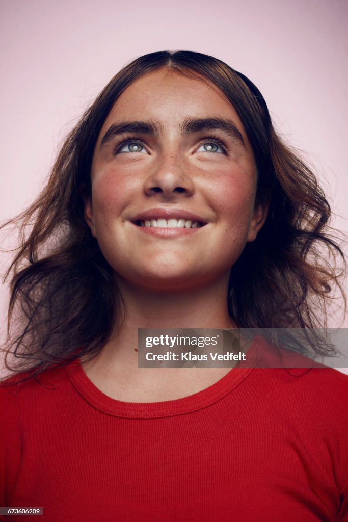 Portrait of beautiful girl looking up and smiling