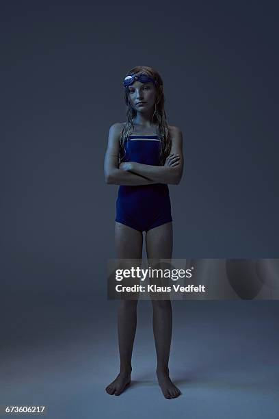 portrait of young swimmer with crossed arms - tween girl swimsuit stock-fotos und bilder